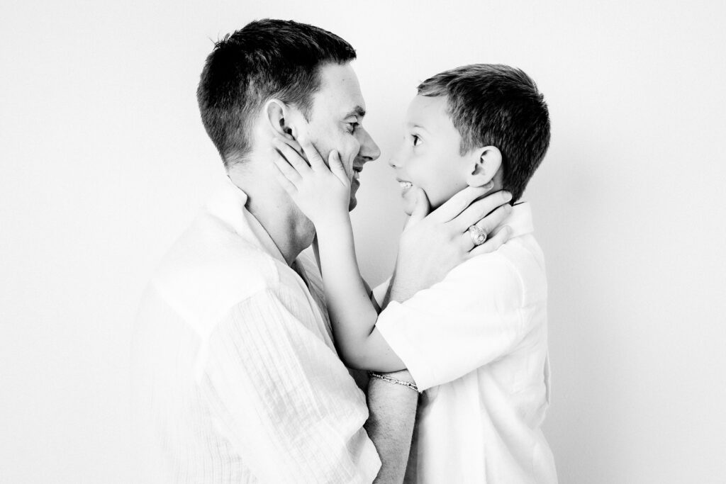 Black and White studio portrait of Dad and son in Katy, TX